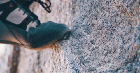 Close up of climbing shoe on tan granite rock Stock Footage 98016653