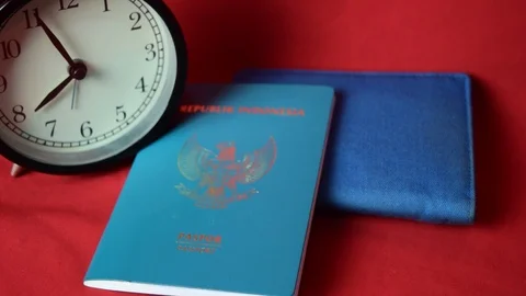 Close up clock, blue wallet and passport, isolated on red background Stock Footage 104137035