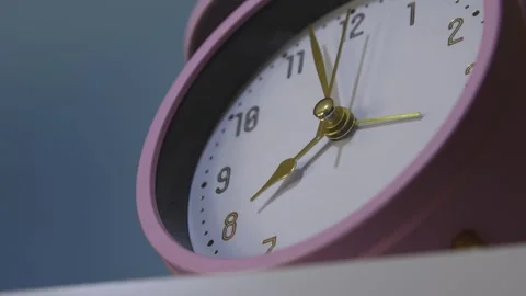Close-up of a clock from the bottom corner. Time is about 8, table alarm cl.. Stock Footage 310495210