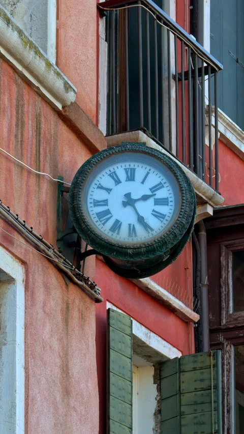 Close up of a clock on the outside of the building in Venice, Italy. Vertical Stock Footage 304402033