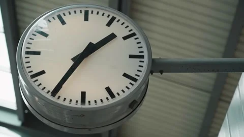Close up of clock at sky train terminal screen in the back and train is coming d Video stock 311797973