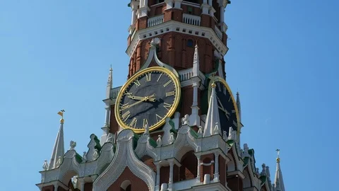 Close-up clock on Spasskaya Tower of the Kremlin against the blue sky on a sunny Stock Footage 110168042