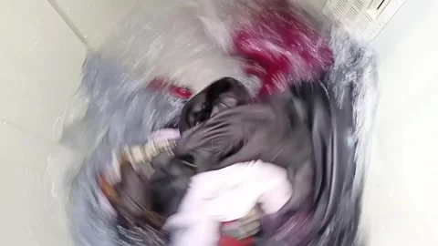 Close Up of Clothes Spinning in Top Load Washing Machine Stock Footage 325062325