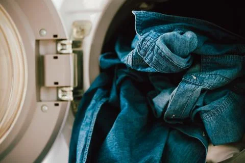 Close up clothes in washing machine background. Laundry concept. Stock Photos