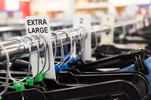 Close up of a clothing rack with extra large clothing size tags Stock Photos