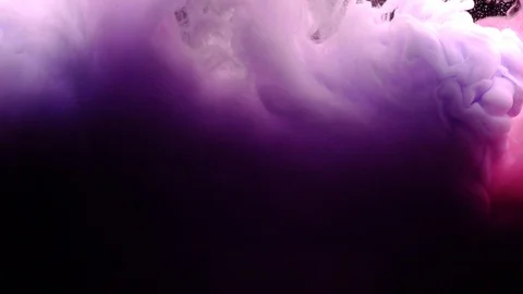 Close-up of cloud of pink purple and white colors explode under water Stock Footage 114321665