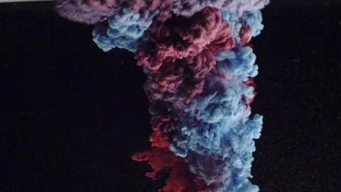 Close-up of cloud of purple and pink colors explode underwater Stock Footage 114321578