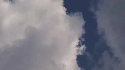 Close up cloud texture with white and gray clouds meeting in blue sky Stockbeeldmateriaal 333727827