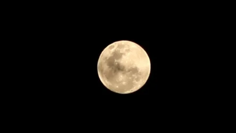 Close up of clouds drifting over and covering the full super moon  Stock Footage 101635415