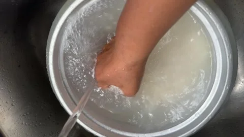 Close-up of cloudy rice water inside metal Stock Footage 325300579