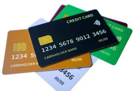 Close-up cluster of overlapping multi-colored credit and debit cards on a w.. Stock Photos