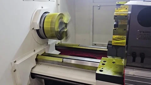 Close-Up of CNC Lathe Machine Rotating a Metal Workpiece with Precision Stock Footage 336173647