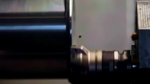 Close up of CNC lathe machine turning a metal part in factory workshop Stock Footage 332403987