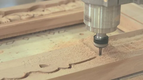 Close-up of CNC machine cutting and shaping a wooden furniture part. Close-up of Video stock 347575948