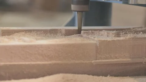 Close-up of CNC machine cutting and shaping a wooden furniture part. Close-up of Video stock 347575965