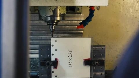 Close up of a CNC milling machine drilling material during industrial Stock Footage 341569444