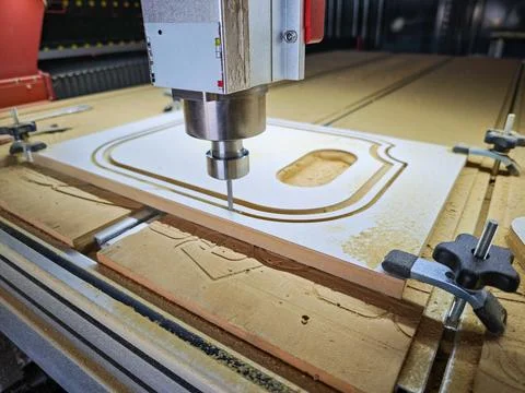 Close-up of CNC router machine milling a precise pattern on a wooden board Stock Photos