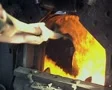 Close up of coal being shovelled into furnace SD Footage