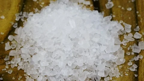 Close-up of coarse grains of salt on a rotating plate Stock Footage 261344357