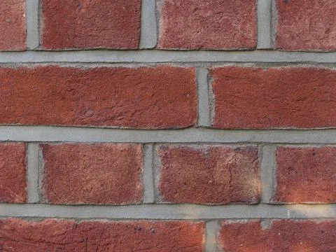 Close up of coarse red brickwork with grey mortar Stock Photos