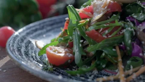 Close-up of coarsely chopped Caesar salad with chicken fillet in the ceramic Vídeos de archivo 204870159
