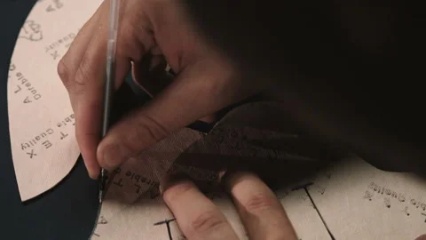 Close up of a cobbler stitching a part of the shoe at a workshop Stock Footage 95896341