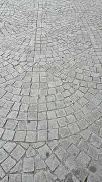 Close-up of a cobblestone pavement with a fan-like pattern Stock Photos
