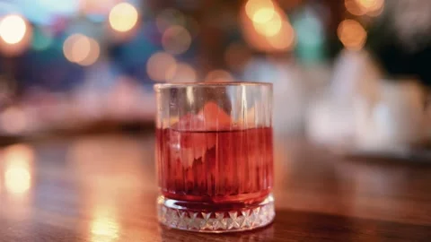 Close up of a cocktail glass containing ice and citrus slices Stock Footage 325814915
