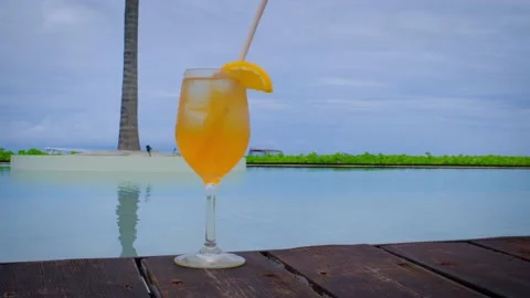Close up of cocktail with a swimming pool. Video stock 229704608