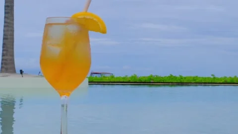 Close up of cocktail with a swimming pool. Video stock 230170556