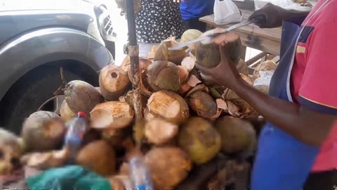 Close Up of Coconut Vendor Cutting Coconut with Machete - Accra Ghana Stock Footage 345514891