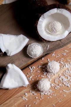 Close up of coconut with white pulp, coconut chip and white candies on wooden Stock Photos