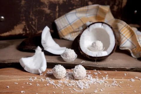 Close up of coconut with white pulp, coconut chip and white candies on wooden Stock Photos