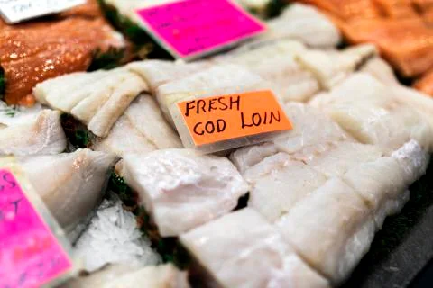 Close up of cod loin fillets with an encapsulated luminous orange hand writte Stock Photos