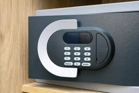 Close-up of code lock on opened iron safe door at hotel room Foto stock