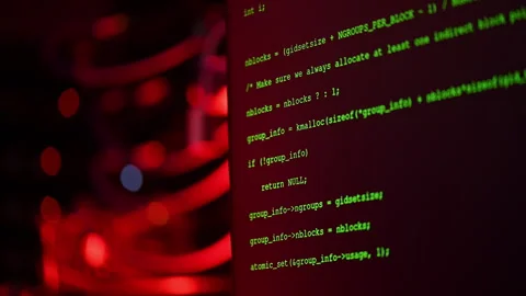 Close up of code on a screen in a server room with flashing red lights 스톡 동영상 287370820