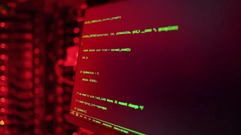 Close up of code on a screen in a server room with flashing red lights 스톡 동영상 287377730