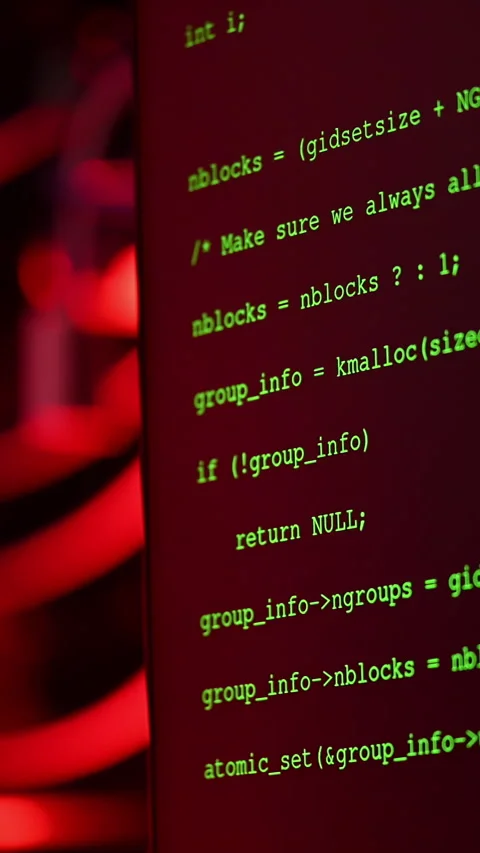 Close up of code on a screen in a server room with flashing red lights. Vertical Stock Footage 287378987