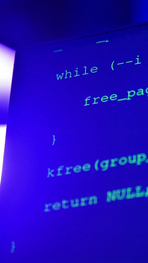 Close up of code on a screen in a server room with flashing colourful lights. 스톡 동영상 287379053