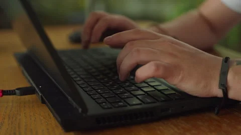 Close-up of coders hands typing on laptop, programming in a tech environment Stock Footage 264476703