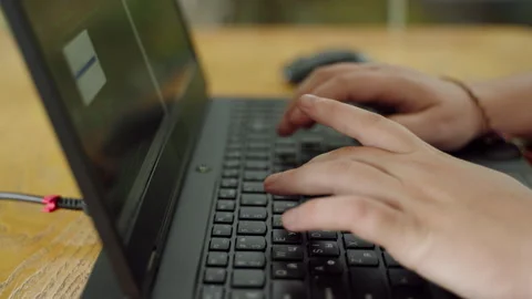 Close-up on coders hands typing on laptop, programming software at wooden desk Stock Footage 265953982