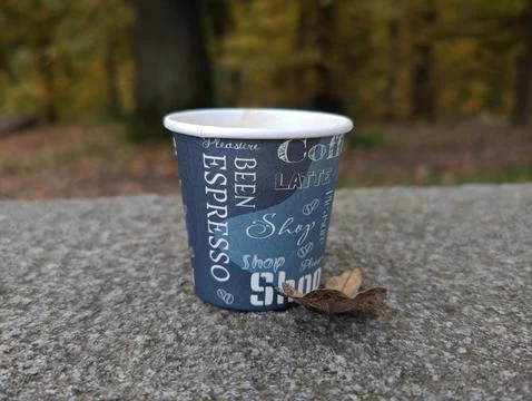 Close-up of coffee against the backdrop of a park Stock Photos