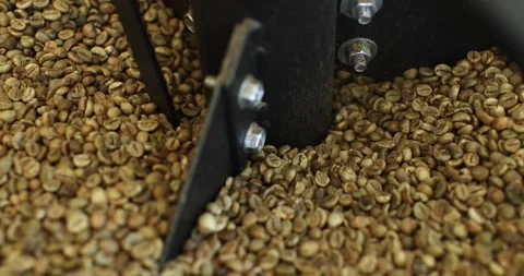 Close-up. Coffee beans are roasted in a vat at the factory. Modern equipment. Stock Footage 239056940