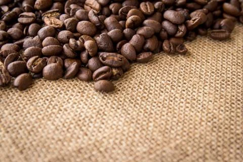 Close up of coffee beans on burlap background Stock Photos