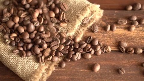Close-up of coffee beans on burlap on a dark wooden background Stock Footage 197771228