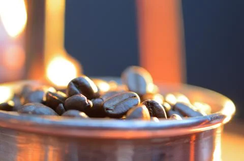 Close up coffee beans  to in a copper container on a dark background Stock Photos