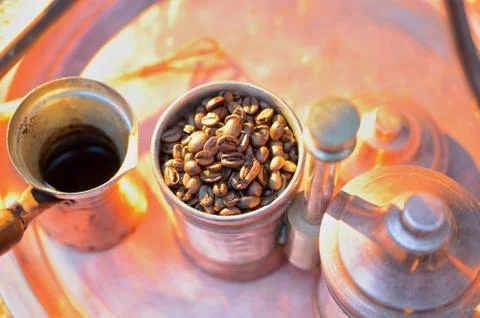 Close up coffee beans to in a copper container on a dark background Stock Photos