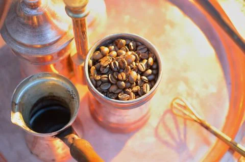 Close up coffee beans to in a copper container on a dark background Stock Photos