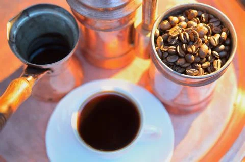 Close up coffee beans to in a copper container on a dark background Stock Photos