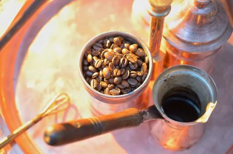 Close up coffee beans to in a copper container on a dark background Stock Photos